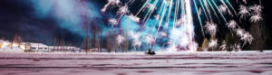 man on snowmobile enjoying snowfest fireworks display