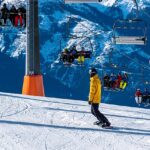 snowboarder by ski lifts